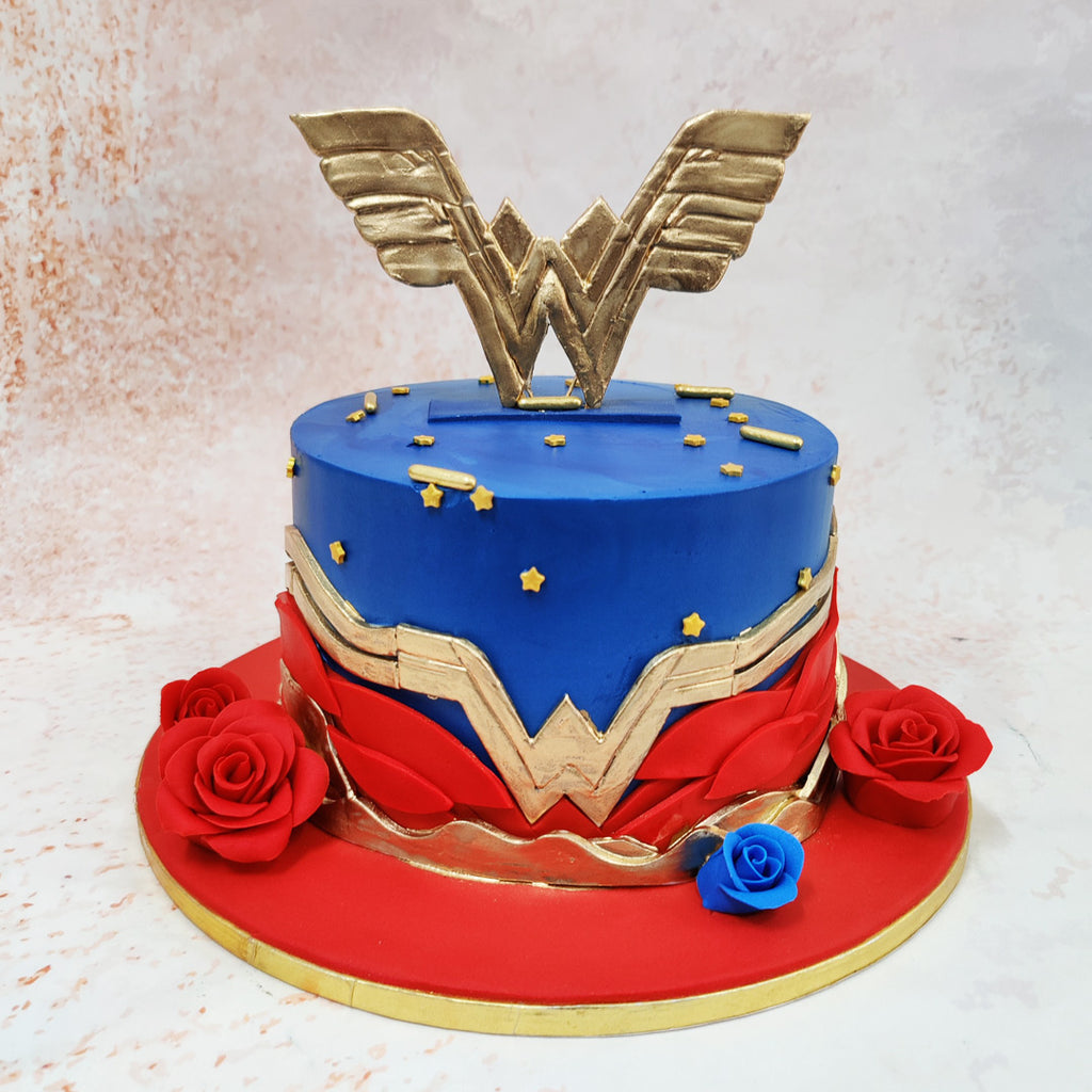 The centrepiece of this Superhero Theme Birthday Cake is a magnificent golden eagle emblem crowning the top tier, reflecting Diana's strength and soaring spirit. 