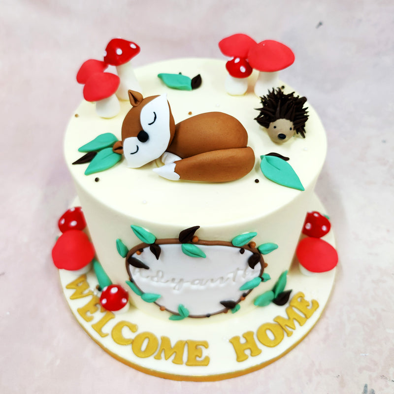 Atop this Woodland Cake, a peacefully sleeping fox curls up beside a spiky little hedgehog, both nestled among fondant leaves and vibrant red mushrooms with sugary white spots. Their miniature world feels lifted from the pages of a children’s storybook—serene, safe, and full of quiet wonder.