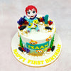 Sitting right at the top of this Yellow Baby Shark Cake is an adorable fondant figure of Bebefinn, clutching his cheerful yellow shark pal and beaming with first-birthday wonder. His wide eyes and tiny paws give the whole piece a playful, animated charm—as if he’s just paused mid-dance from a deep-sea singalong.
