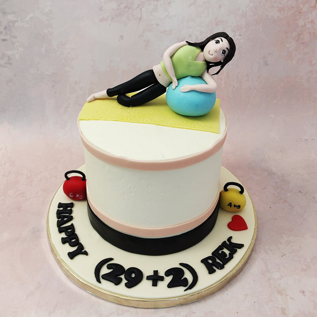 Equipped with a yoga mat, exercise ball and a figurine of a lady stretching on top of a clean, white base, this workout cake pays homage to something that it or rather should be an integral part of all our lives.