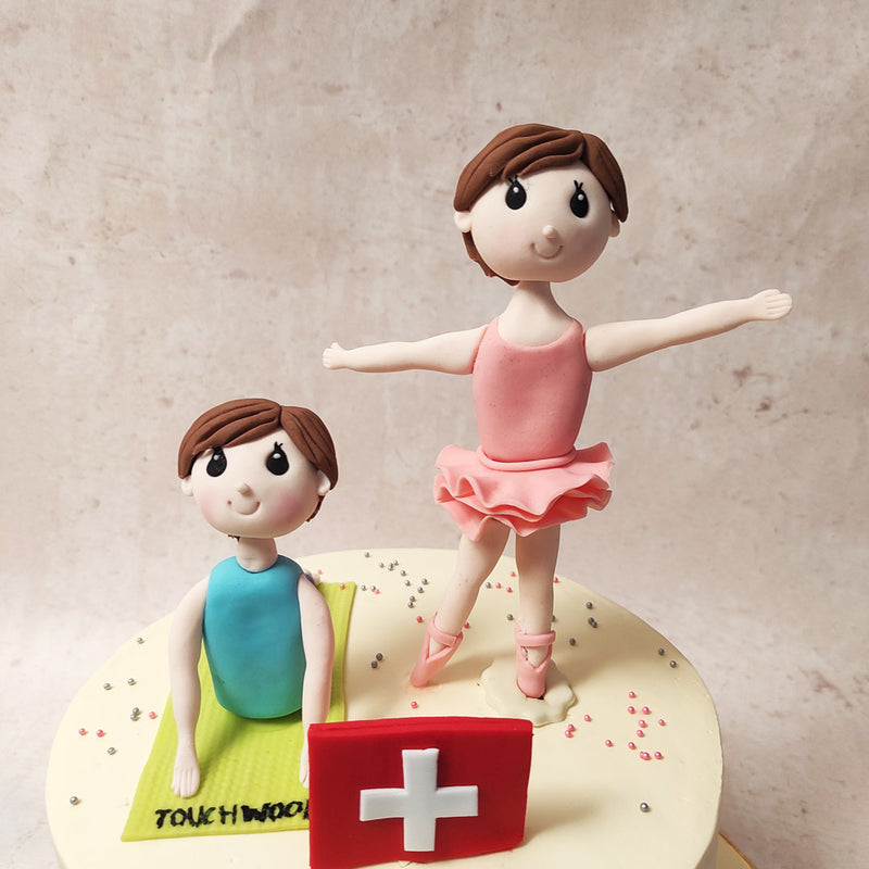 Perched atop this ballet dance cake are two finely crafted figurines - a ballerina in a soft pink tutu, poised mid-pirouette, her form embodying the grace and discipline of ballet. 