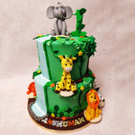 This Elephant and Giraffe Cake has a green base, adorned with intricately crafted green vines, instantly captures the essence of a dense jungle.