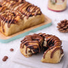 Christmas chocolate sweet roll pulled apart, showing the soft dough, chocolate filling, and chocolate ganache drizzle.