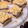 Close-up of Cherry Crumb Cake squares, showing the buttery cake base, cherry filling, and golden crumble topping.