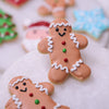 Close-up of a gingerbread man Christmas sugar cookie decorated with white icing and buttons