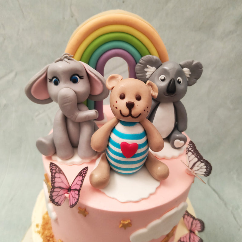 While celebrating a successful first year, we have double the excitement with this two tier animal first birthday cake. The bottom tier is like the base of a coral reef with a blue ombre pattern gradiatiantly changing from blue to neutral buttercream tones. 