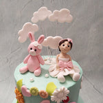  As a 1st year birthday cake for kids, this two tier design features a sky-blue colour palette laden with fluffy white clouds and ornamented with creatures of the imagination: sheep, butterflies, bunnies and birds.