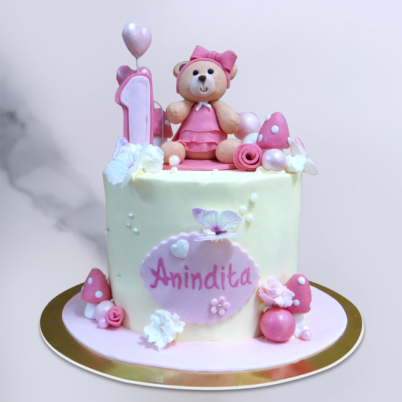 Your search for a 1st birthday cake for baby girls ends here. We present you this pink teddy bear with lot of pink and white elements that your baby will surely love. This birthday cake for girls also hold a cute little teddy bear with a pink dress
