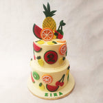 The colour palette of white meets bright, gives this two tier fruit theme cake a ravishing and vibrant aesthetic, enabling the design to look like a tall and elegant fruit platter.