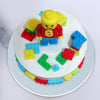 The classy and clean white base of this lego cake design highlights the colours of the lego blocks surrounding the frame of the lego theme cake