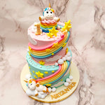 Each tier of this two tier unicorn birthday cake for kids comes adorned with celestial elements that have been recreated in a three-dimensional format. First we have the rainbow stripes that diagonally adorn both tiers of this two tier unicorn cake that are both accompanied and complemented by the yellow stars and fluffy cloud cut-outs that embellish this 2 tier rainbow unicorn cake all over. 