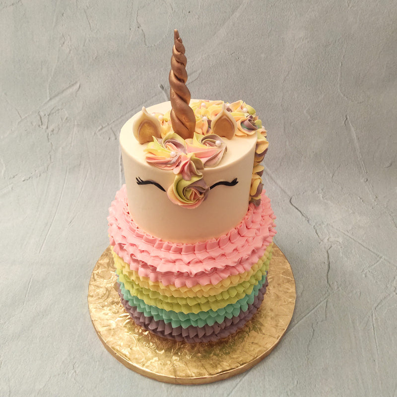  Replicating a rainbow as well as a colourful piñata containing several treats, this two tier unicorn birthday cake for kids combines the best of both worlds.