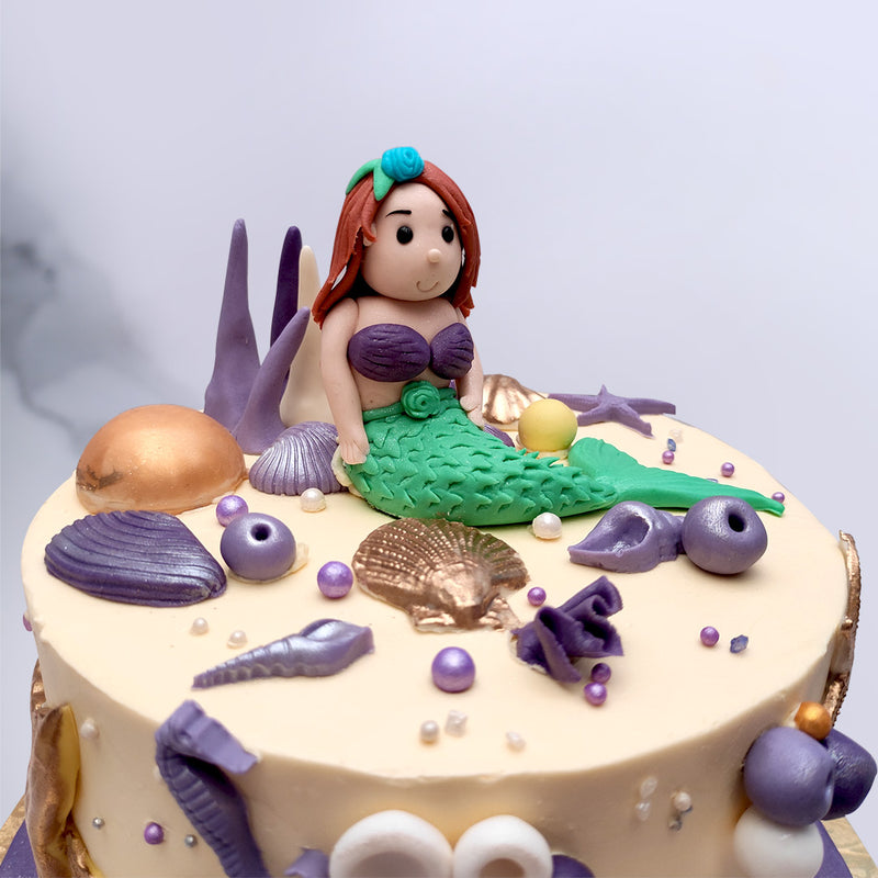 Zoom view of aerial cake which is actually a mermaid theme cake with lot of colourful elements on top of the cake