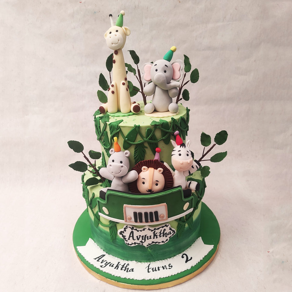  The three animals on the bottom tier of this jungle theme cake seem to be the ones on the safari, ironically. 