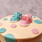 Top view of baby boots cake or baby shower cake where you can see baby boots of different colours like pink and blue which depicts both the gender of a boy or a girl 