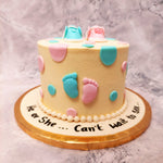 Front view of baby shower cake with baby boots on top to showcase you the small baby feet figurines in different colour to capture the theme of baby shower gender reveal