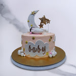 With this baby shower theme cake, all eyes will be drawn to the wee baby asleep on the welcome baby cake bed in warm pink. The moon and stars are surrounding him/her in this baby shower cake design and the base of has fluffy clouds and golden stars on it.