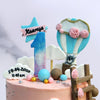 This hot air balloon cake has stars, clouds, flowers, wooden stairs and a small teddy bear in a Hot Air Balloon.