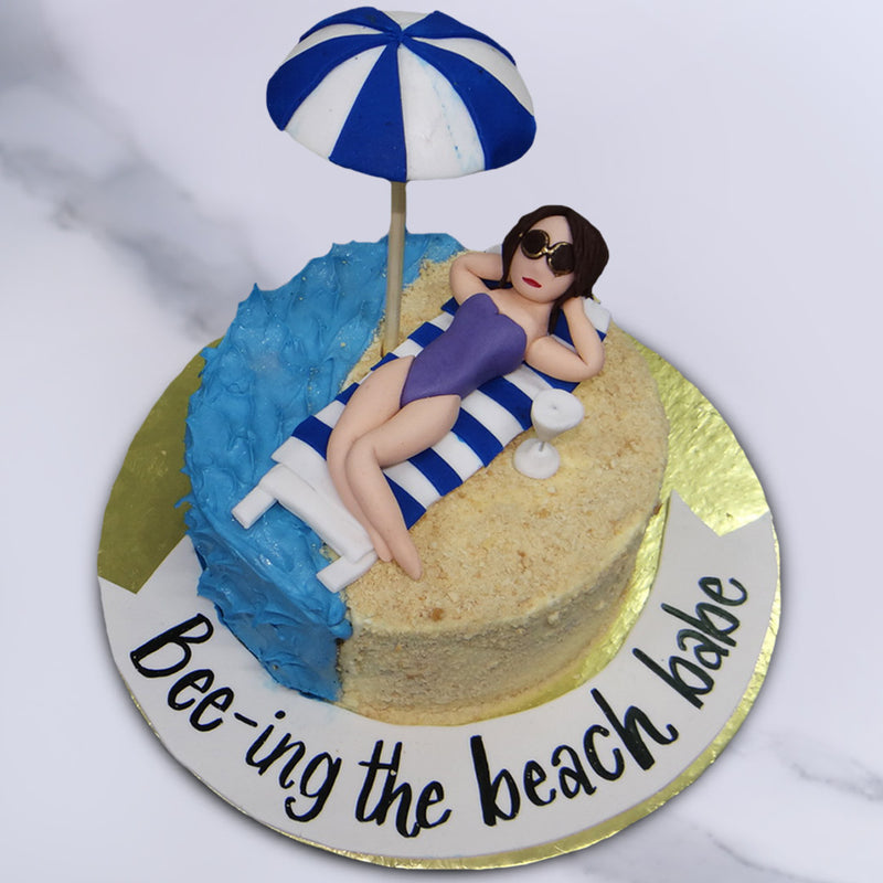 The detailing of this beach theme cake for girls includes the addition of her fancy sunglasses, red hot lipstick and the crumb texture of the sand.