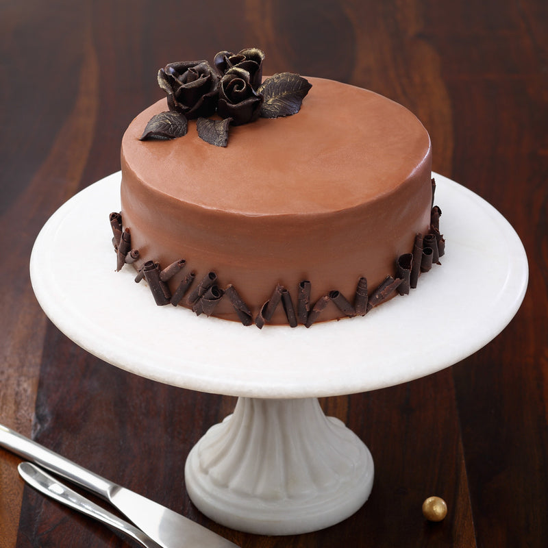 This Belgian couverture chocolate cake is a standard offering from Liliyum patisserie cafe. This chocolate cake has a beautiful decoration of dark chocolate rose on top of the cake. Order online belgian chocolate cake for same day delivery across bangalore 
