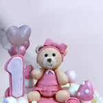 A cute pink teddy bear cake for a first birthday cake for baby girl. A birthday cake which your little one will surely remember for a very long time