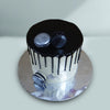 Top view of black and white drip cake with macaroons on top makes the cake look more elegant and classy
