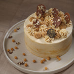 Top view of our butterscotch cake shows the caramel cream pipping and choco chips decorated on top of the cake. This butterscotch cake is a perfect match as a "Happy Birthday Cake"
