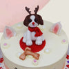 Zoomed view of cake for dog lovers where you can see a spaniel is sitting in a Christmas costume to surprise everyone