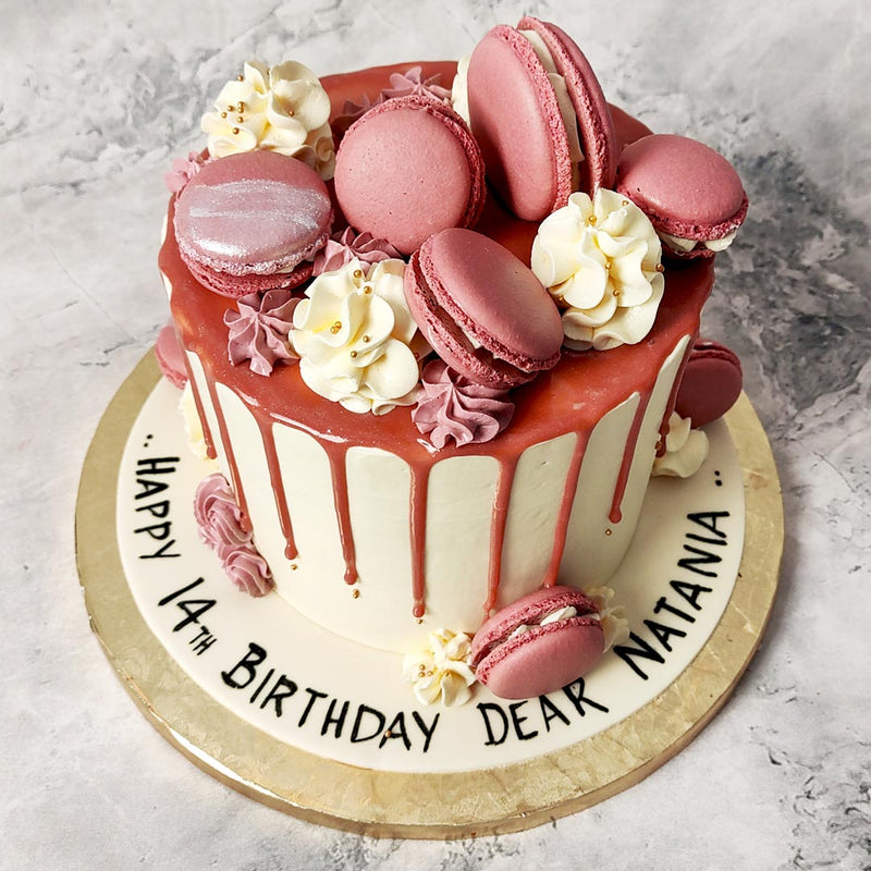 We've used a classy anniversary cake colour theme of pink and white in every element of this macaroons cake from the pink, hard-sponge exterior of each macaroon to their soft, creamy white interior.