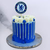Front view of Chelsea cake where you can see white chocolate drips running down the cake 