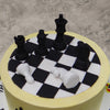 The black and white squares that make up a chessboard form the top or this chess theme cake for her/him and on it are edible pieces of the game, created to be so life-like that you can actually move them, play with them or even eat them.