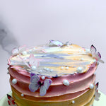 Colorful cake with edible pearls and butterflies on top of the cake 