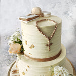 To represent the purity of the event, the color theme  of this communion cake is in a beautiful shade of off white accented with edible gold leaves and an edible gold ribbon that borders the base of each tier.