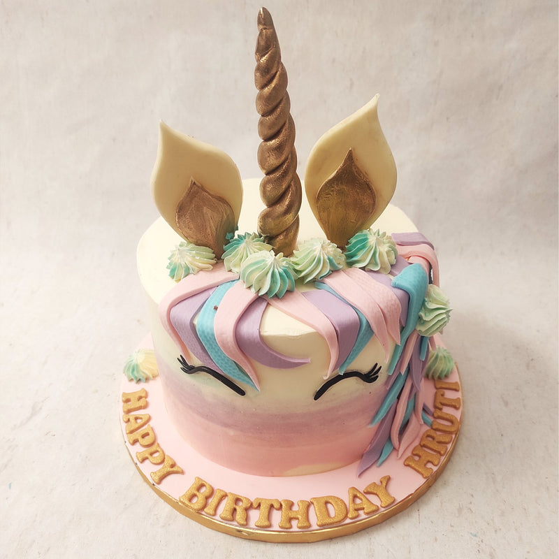 The buttercream eyelashes on this pink and purple Unicorn cake look like this enchanted creature  is peacefully asleep, creating the imagery of tranquility. 