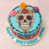 With a light and bright blue base, this Day Of The Dead cake features a skin coloured skull with hollow eyes, reddened around the edges, a wide well-toothed smile and an intricate floral pattern all over. 