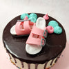 Blue buttercream pipings ornament the top of this shoe birthday cake but the highlight is the pair of pink Birkenstock sandals on top.