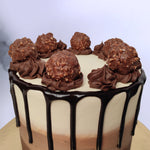 Zoomed view of ferrero rocher chocolate drip cake shows the thick dark chocolate flowing from top of the cake and our delicious ferrero rochers topped over chocolate ganache