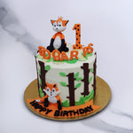 Fox theme birthday cake for a one year old baby who loves watching wild animals. This 1st birthday cake holds two cute fox looking straight at you and ready to play