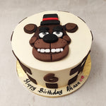 With a white base, brown chess-like squares engulfing the circumference and a Freddy Fazbear's face embellishing the top, this Freddy Fazbear cake design bears an aesthetic that is artistic, simplistic and minimalistic.