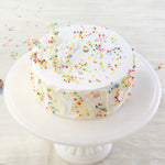 The funfetti vanilla cake is made of layers of soft vanilla sponge, full of rainbow sprinkles and topped with dreamy, mildly sweet cream infused with white chocolate ganache.