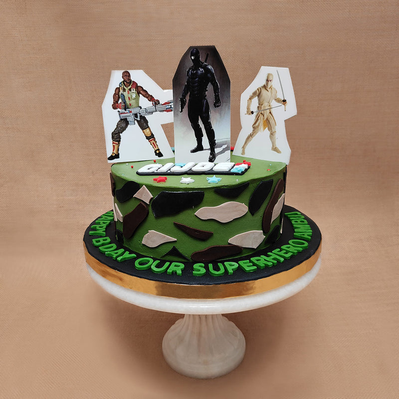 The G.I.Joe logo has been created in edible, two-dimensional form and displayed on top of this kids birthday cake in a very realistic way and green, 2D letters like the colour of kryptonite are used around the base of this G.I. Joe theme cake to display your personal message like this one that says,"Happy Bday our superhero"
