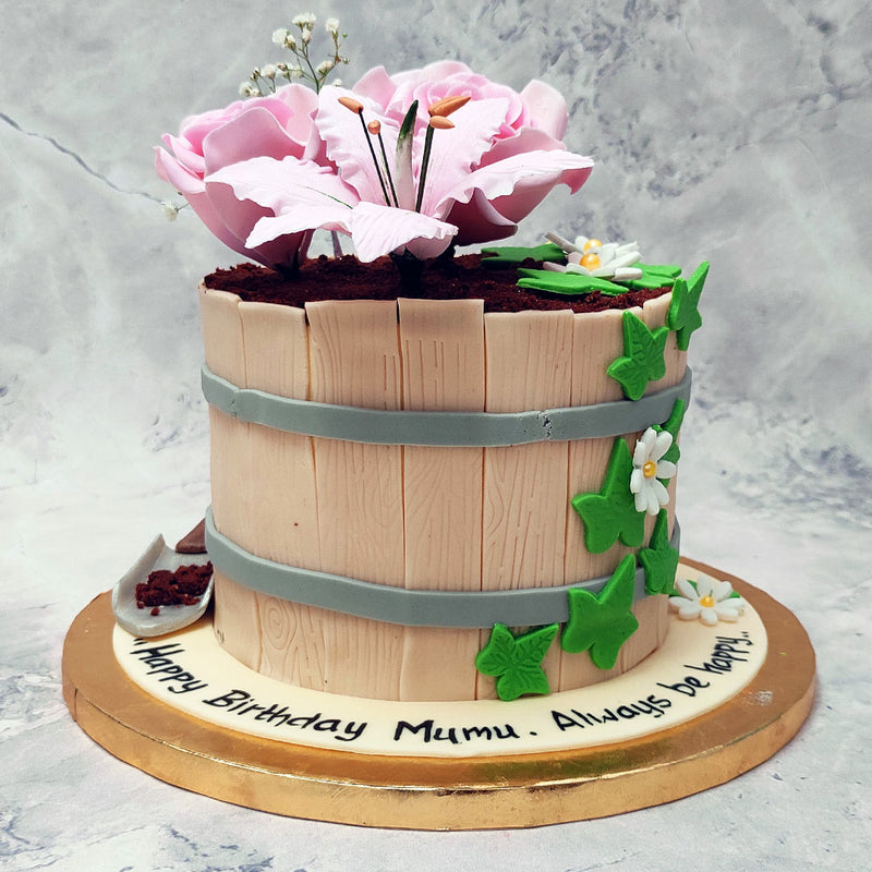 Front view of our garden theme cake paints a pretty picture of having a tea party out in nature. Add a floral touch to your celebrations with a flower cake that's sure to be a decorative show stopper.