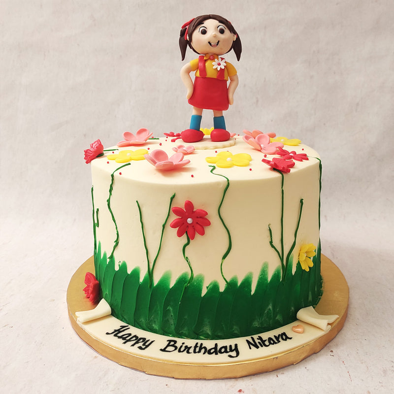 This simple garden birthday cake for girls features a buttercream white base with hand-painted flowers on it.