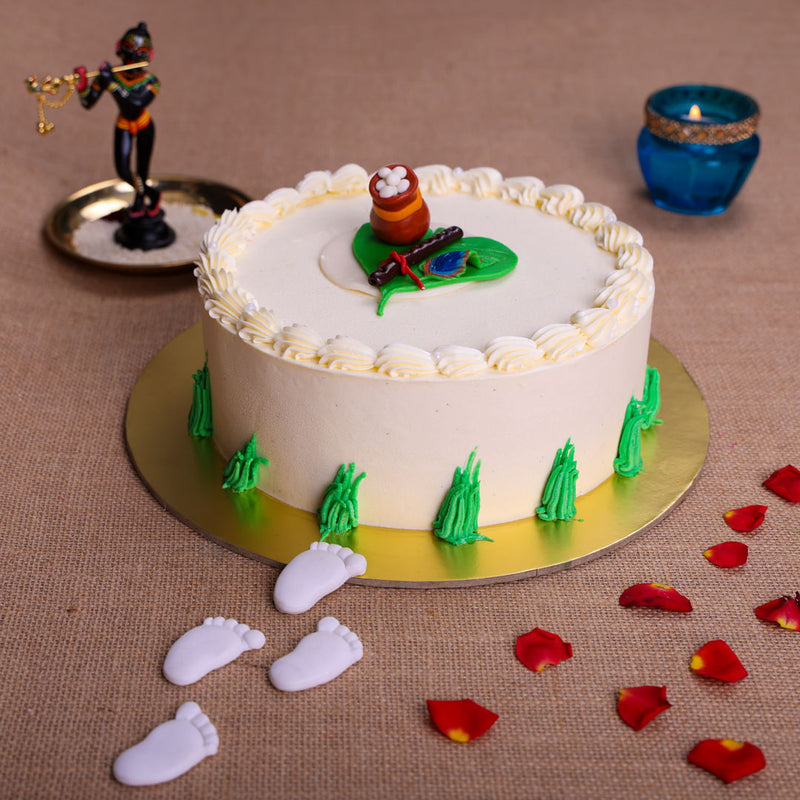 On top of this little Krishna cake design lies his bansuri or flute depicted by a roll of chocolate. This Krishna theme birthday cake has his footsteps made out of delicious almond paste leading up to the delicious pit of butter, enticing not just Kanhaji but all the Balamuralis and Radhas in your house too. 