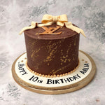 The logo of this global fashion company has been recreated in a two dimensional gold topping for this Louis Vuitton cake with the whole finish of it looking marbleized like the centerpiece at a gala.