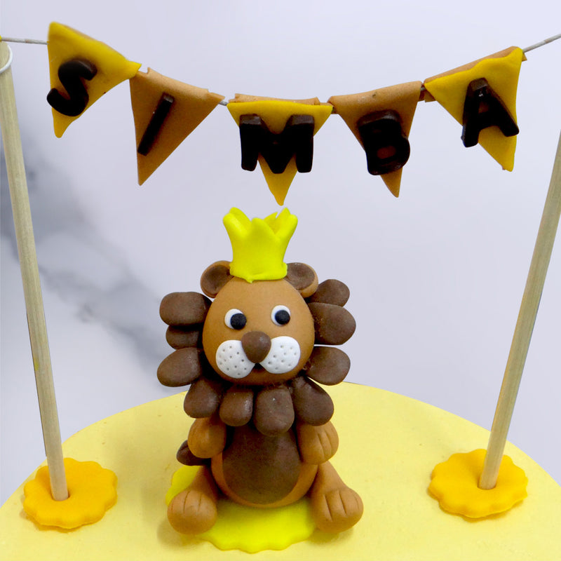 Close up image of Simba the lion king sitting on top of this Lion king half birthday cake. Every kid will love this cake as his celebration as Half birthday cake 