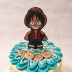Along with the logo of the series and edible gold leaves that look like land markings on a map, this One Piece theme cake also features some pirate skulls along the circumference and a figurine of Luffy on top.