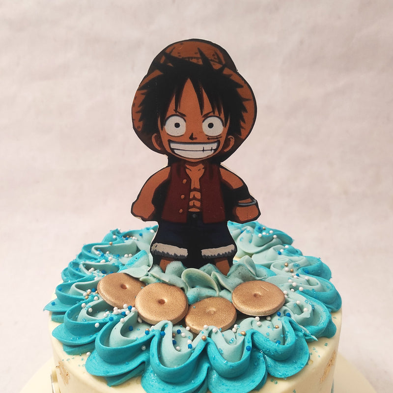 Along with the logo of the series and edible gold leaves that look like land markings on a map, this One Piece theme cake also features some pirate skulls along the circumference and a figurine of Luffy on top.