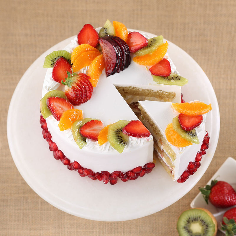 Cakes with fruits on top as well as inside the cake. This vanilla sponge cake is covered with lot of seasonal fruits and white vanilla cream icing. This fresh fruit cake can be delivered within 4-5 hours any where in Bangalore 