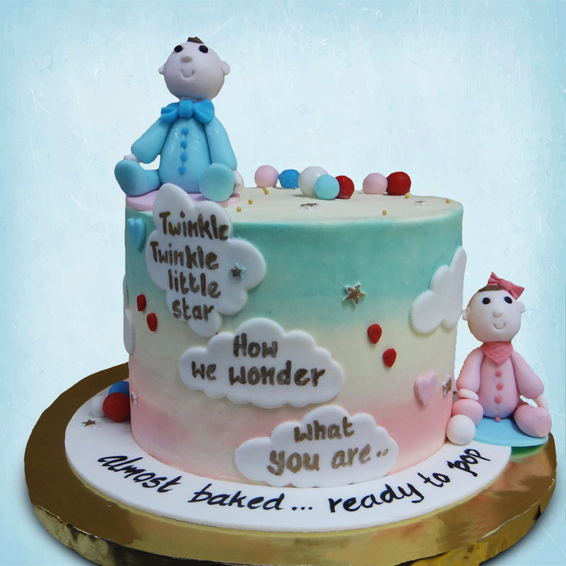 The little boy and girl dolls that decorate this 'he or she' cake are completely edible. The boy doll is dressed in blue from his boy tie to his onesie and the girl doll in pink to keep it gender balanced or even to portray a gender reveal.